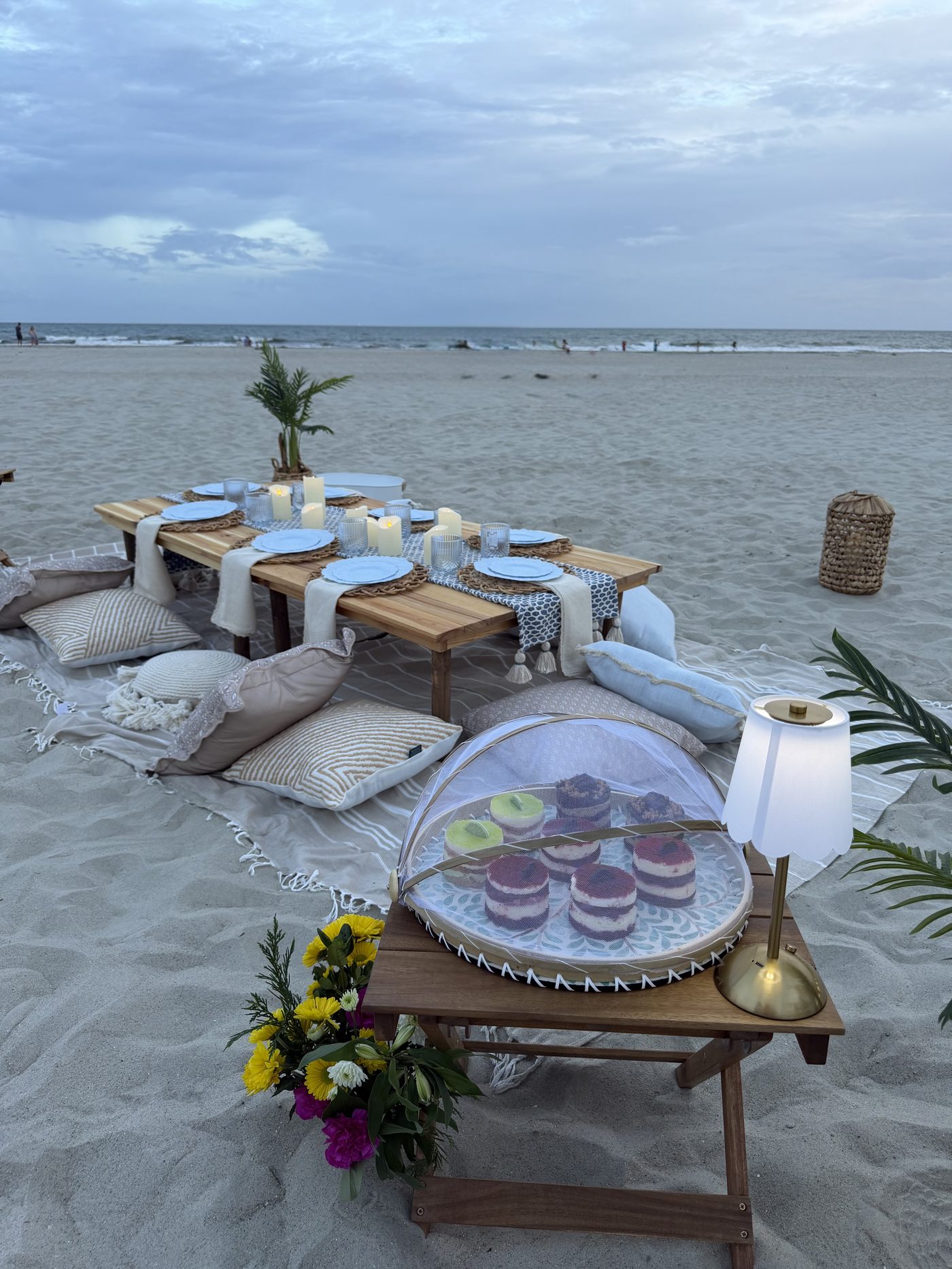 Beach picnic setup with dune grass at dusk on Oak Island