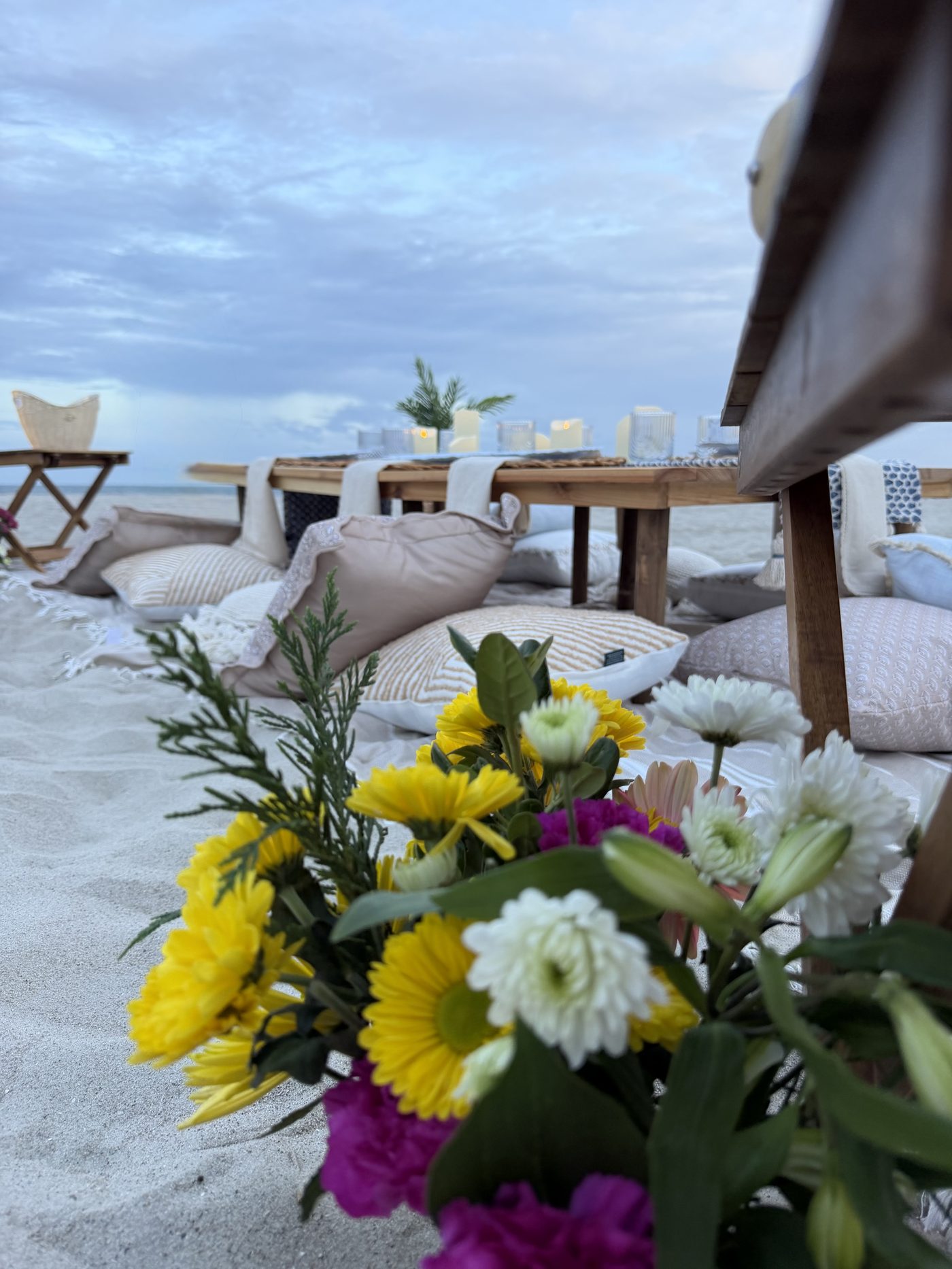 Fresh florals beside the beach table